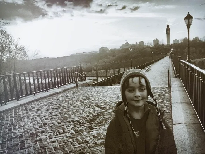 outdoors, boy, child, street, city, bridge, river, hat, jacket, Deborah Bradley-Kramer, MUSE Academy