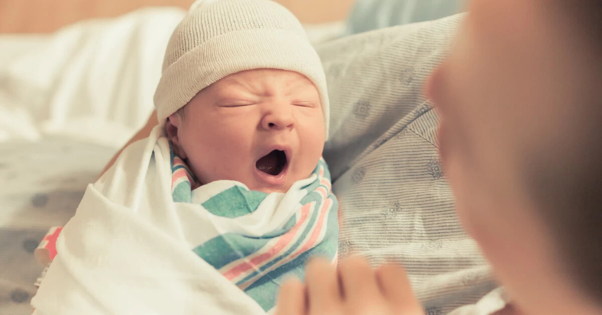 mother holding newborn baby
